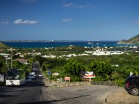 A view of the road leading down towards Grand Case coming from Marigot. In the distance you can clearly see the island of Anguilla. Again, on the left is a bus and a very long line of traffic backed up behind him. You get used to the delay after a while and truth be told because the island is so small at worst it makes a 30 minute journey take about 45 minutes. Not really a big deal when you&#39;re on vacation.